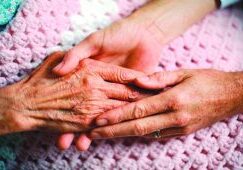 Holding Hands with Elderly Patient Holding Hands with Elderly Patient --- Image by © Wernher Krutein/Corbis